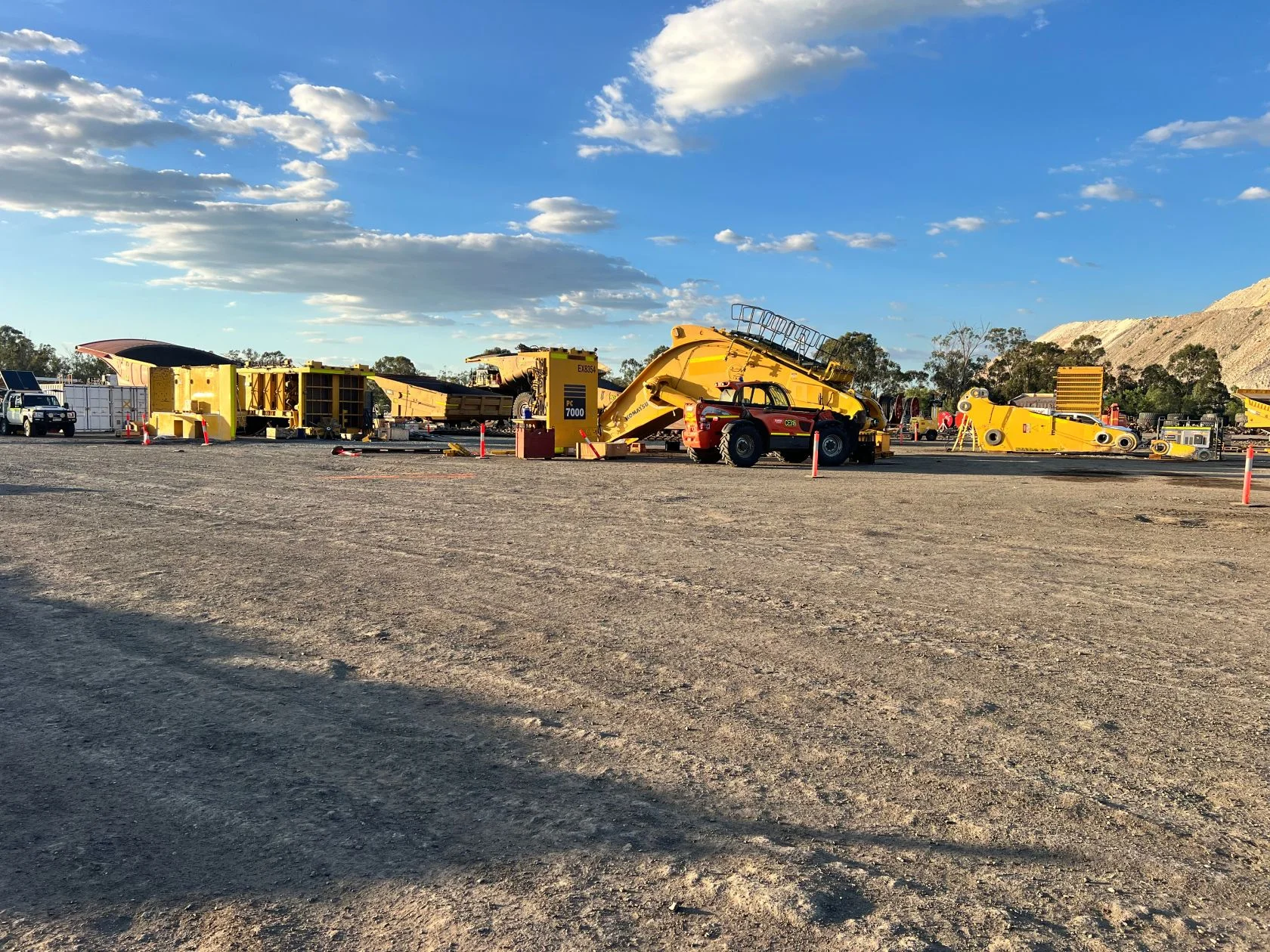 Komatsu haul truck and excavator at a Queensland mine site at sunset